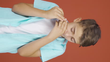 Vertical-video-of-Sick-boy-coughing.
